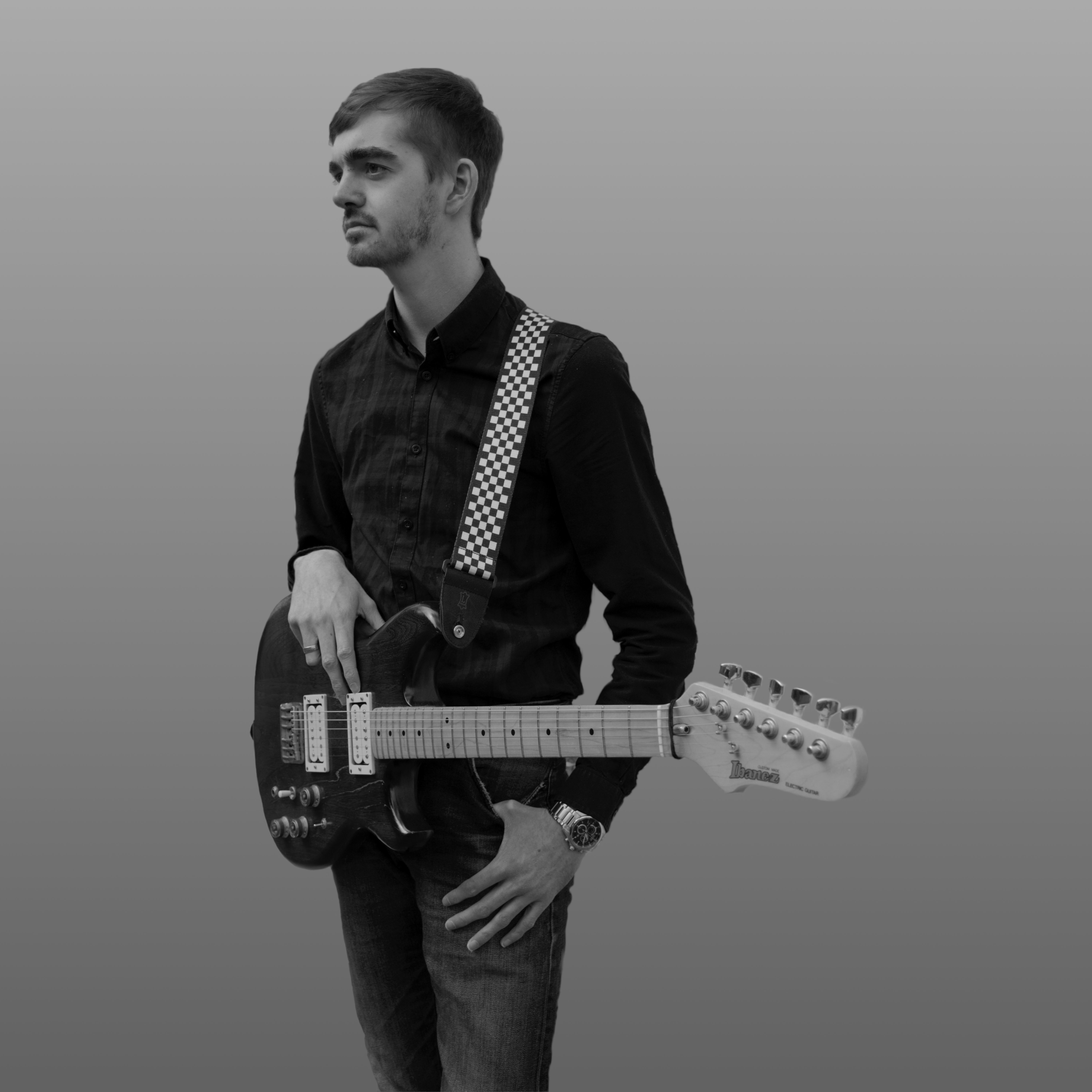 Black and white image of person with a guitar